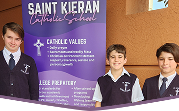 Three boys in school uniform in front of St. Kieran School banner